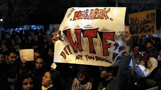 Jordanian demonstrators hold anti-Mubarak banners as they protest outside the Egyptian embassy in Amman.