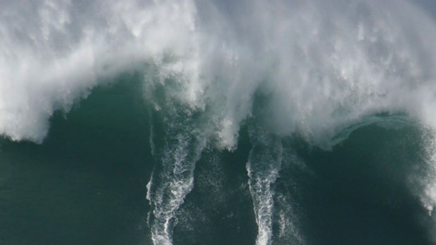 Monster mash . . . Two surfers ride a 50-foot wave at Waimea Bay.