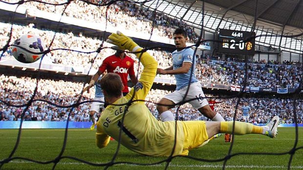 Sweet timing: An unmarked Sergio Aguero scores his second goal against Manchester United on Sunday.