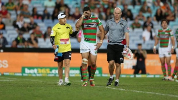 Concussed: Greg Inglis is taken from the field in the game against Wests Tigers.
