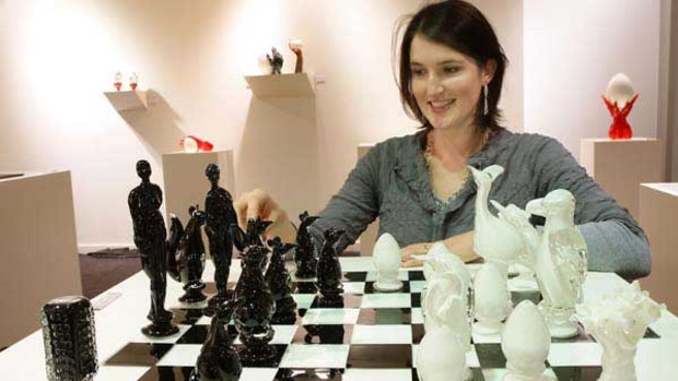 Crystal Stubbs with a chess board from her exhibition.