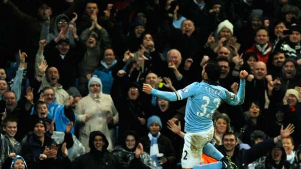 Superman ... Carlos Tevez celebrates after one of his two goals for Manchester City in their 4-3 win over Wolverhampton Wanderers. The Argentinian has now scored 12 goals for the season to rise to second on the top scorers list.