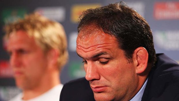 Martin Johnson, manager of England, looks dejected with Lewis Moody.