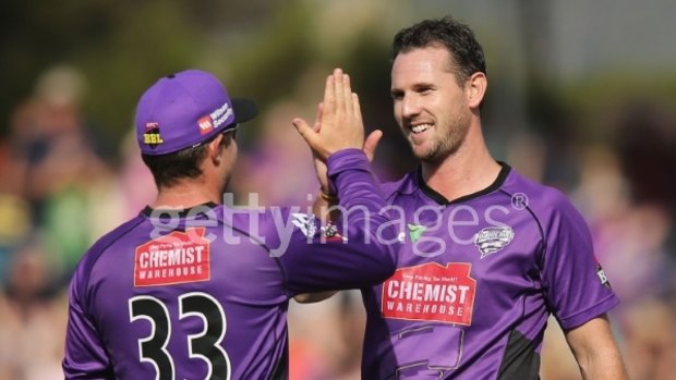 High five: Shaun Tait celebrates a wicket with Hurricanes teammate Michael Hill during the Big Bash League match against the Perth Scorchers.