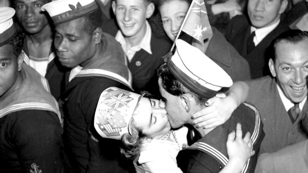 Sydney celebrated the end of the war in high style. A woman kisses a sailor in Martin Place.