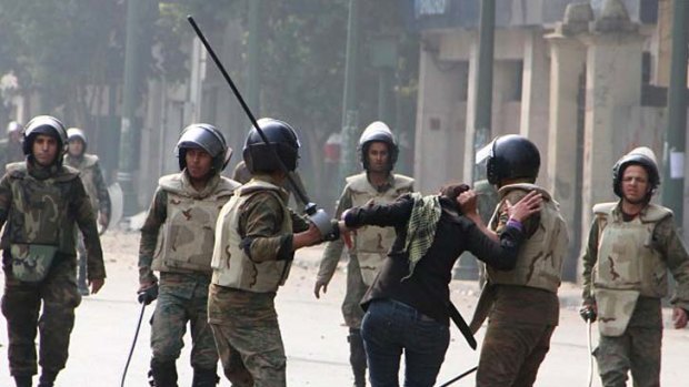 Images of Egyptian soldiers grabbing a female protester by the hair spread across social network Twitter.