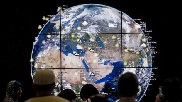 People look at a ''digital Earth'' displayed at Kuala Lumpur International Airport.