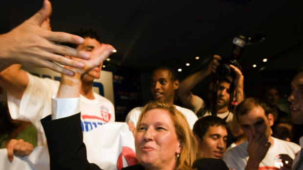 Foreign Minister Tzipi Livni shakes hands with young supporters  in Tel Aviv. She won by only 431 votes out of