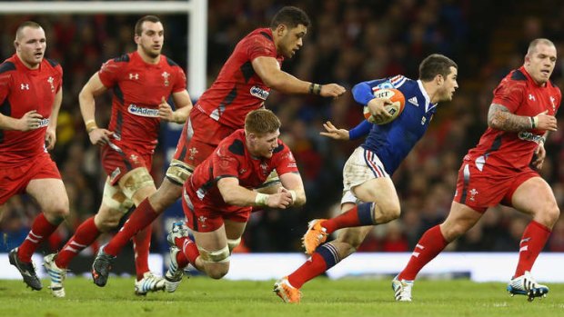 Nowhere to hide: Brice Dulin of France evades the Welsh defence.
