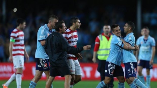 All fired up: Hagi Gligor, second from left, restrains Ali Abbas during Saturday's A-League Sydney derby during which Abbas claims he was 'racially and culturally abused.'