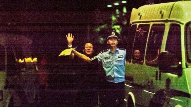 Chinese police take away Matthew Ng.
