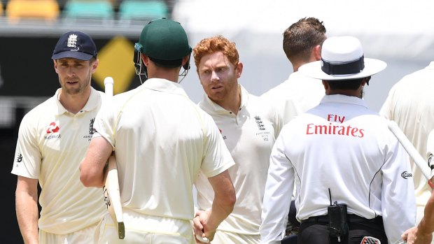 Jonny be good: Bairstow extends his hand instead of his head to Cameron Bancroft as Australia completes victory in the first Test on Monday.