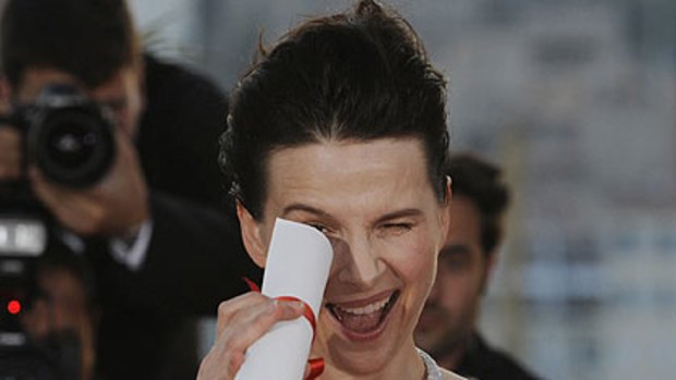 'Beautiful miracle'...Juliette Binoche collects her Best Actress award at Cannes.