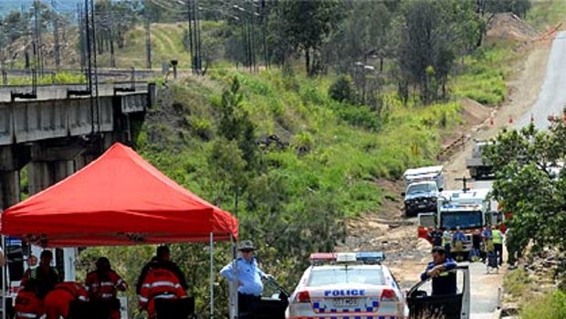 Police retrieve a body from a utility washed away in floods on the central Queensland coast.