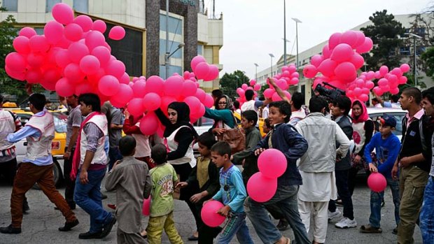 Peace project: Afghan volunteers distribute balloons to residents during "We Believe In Balloons", an art project promoting peace in Kabul.