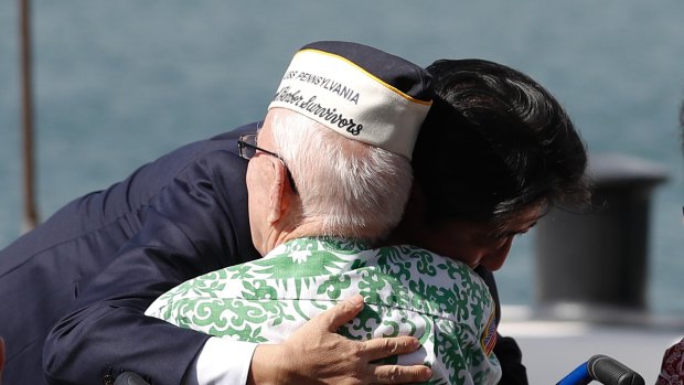 Japanese Prime Minister Shinzo Abe embraces World War II Pearl Harbour survivor Sterling Cale.