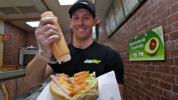 Shift of focus: James Hasson puts the finishing touches to a sandwich in Cronulla this week. Hasson hopes to win a bench spot for the grand final.