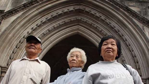 Correcting past injustices ... Loh Ah Choi, left, arrives at the High Court with Chang Koon Ying, right, and Lim Ah Yin, centre, to force a public inquiry into the killing of unarmed Malaysian rubber plantation workers in 1948.