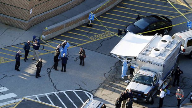 Officials standing outside of Sandy Hook Elementary School in Newtown, Connecticut in December 2012.