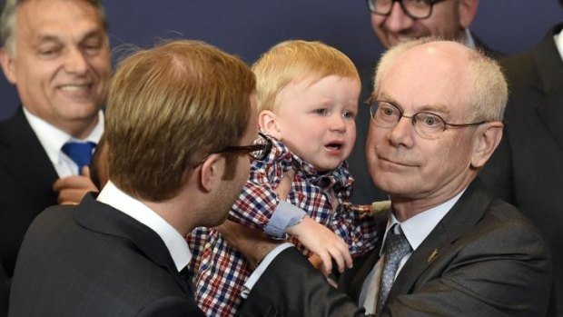 For the next generation: European Council President Herman Van Rompuy holds one of his grandchildren before an official family photo with European heads of state and government during a European Union summit at the EU headquarters in Brussels.