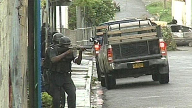 Riot police take to the streets in West Kingston, Jamaica.