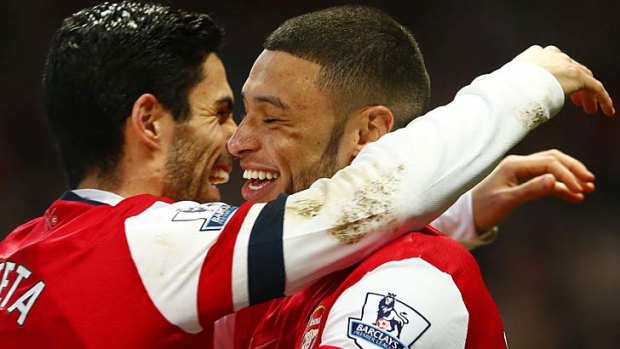 Winners are grinners: Arsenal's Alex Oxlade-Chamberlain (right) celebrates with Mikel Arteta.