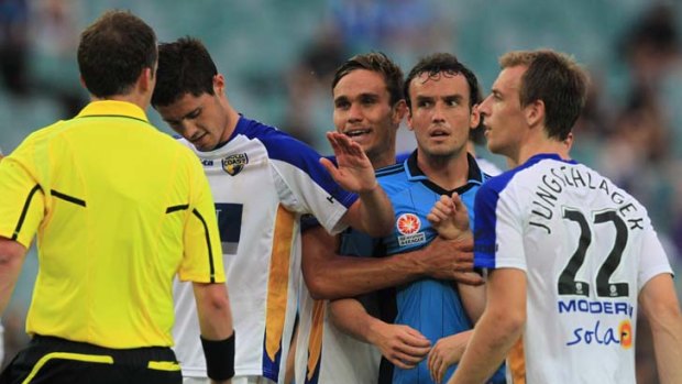 United stance &#8230; furious Gold Coast players surround referee Peter Green after he awarded a controversial injury-time penalty.
