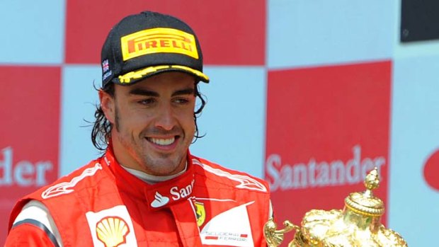 Fernando Alonso celebrates on the podium.