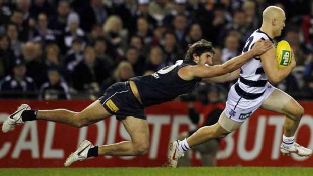 Gary Ablett puts on the pace to evade a desperate tackle from Jarrad Waite in Geelong's 42-point win last night.