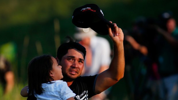 Jason Day walks off the 18th green with his son Dash after winning the 2015 PGA Championship.
