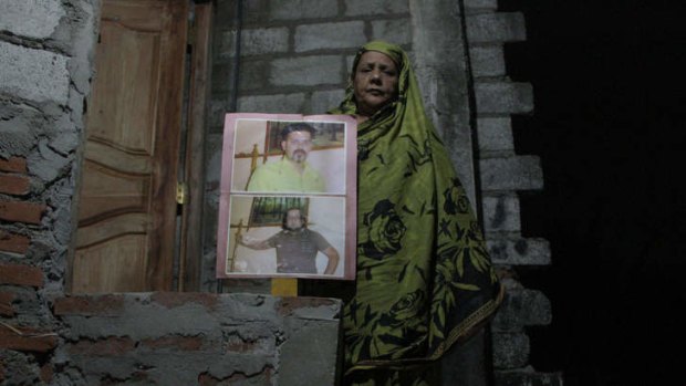 Mother's protest: Noor Najeeb stands outside her house in Colombo holding a picture of her sons who were taken in a "white van abduction" in May 2010.