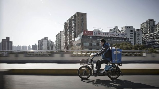 A ZTO Express courier on his delivery route in Shanghai.