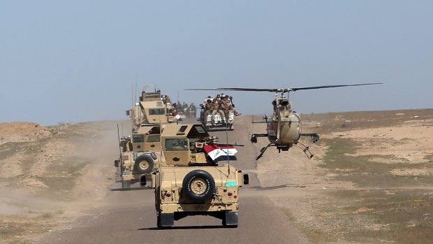 Iraqi Defence Minister Khaled al-Obeidi's convoy tours the front line in the Samarra desert, Iraq, earlier this month.