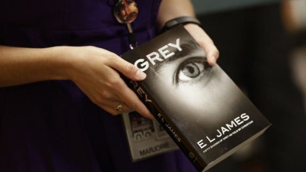 Top seller ... A Barnes and Noble employee holds a copy of EL James' new book Grey. Despite harsh reviews, the novel has already sold over 1 million copies.