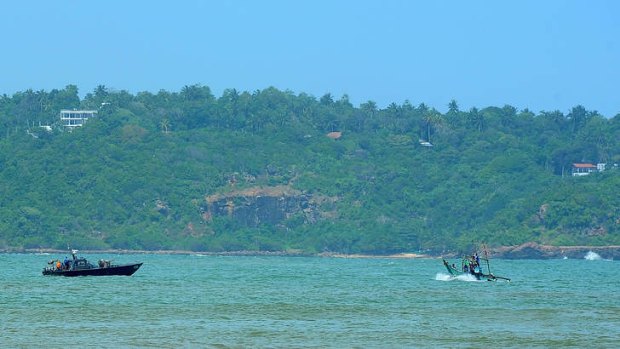 A Sri Lankan navy boat (left) on patrol in the southern port of Galle.