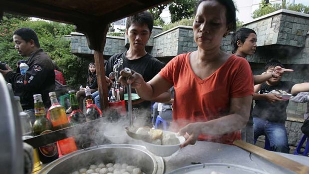 Boiling broth ... a bakso vendor serves up the dish in Jakarta this week.