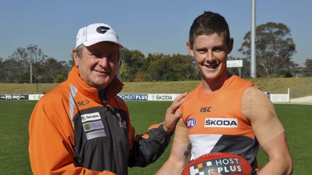 Finally there &#8230; coach Kevin Sheedy congratulates Sam Darley on his call-up against Brisbane this weekend.