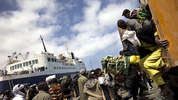 Hundreds of migrants flee fighting in the besieged Libyan city of Misrata.