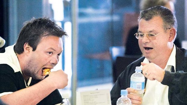 Hard to swallow: Carl Williams and his father George have a bite to eat outside court in April 2004.