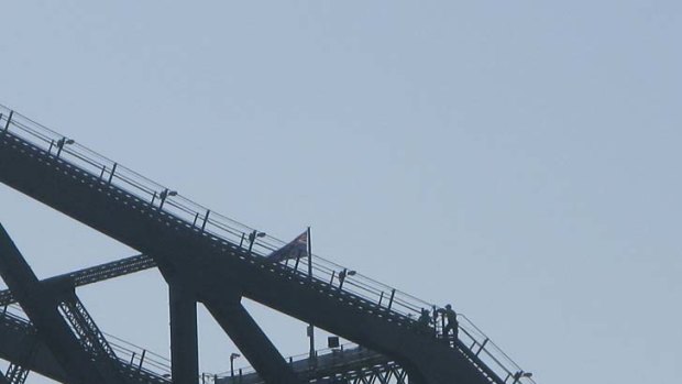 The protester appears to speak to a policeman on the bridge in this photo taken at 7am.