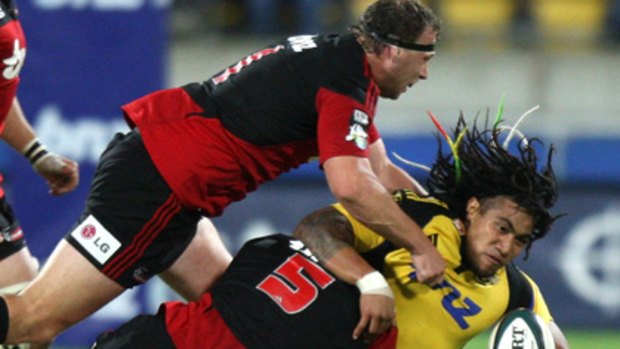 Ma a Nonu of the Hurricanes is tackled by Sean Maitland.