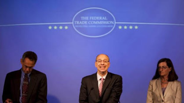 Federal Trade Commission (FTC) Chairman Jon Leibowitz, center, accompanied by Bureau of Competition Director Richard Feinstein, left, and FTC Commissioner Julie Brill, takes part in a news conference at the FTC in Washington to discuss the Intel antitrust case.