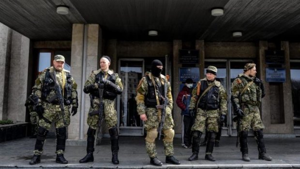 Armed pro-Russian activists stand outside the Ukrainian regional administration building in the eastern Ukrainian town of Sloviansk.  