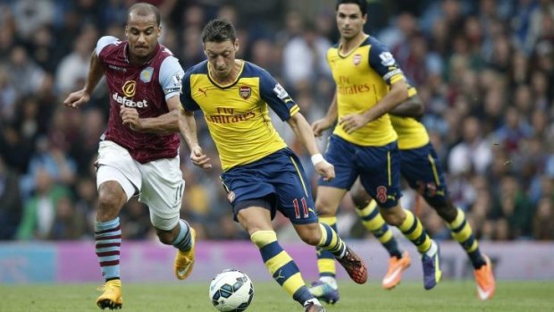 Arsenal's Mesut Ozil makes tracks for goal with Aston Villa's Gabriel Agbonlahor in hot pursuit. 