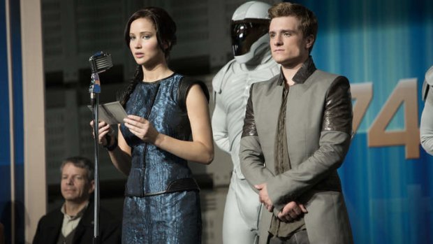 Deadly publicity tour: Katniss Everdeen (Jennifer Lawrence) and Peeta Mellark (Josh Hutcherson) become symbols of a rebellion and targets of the Capitol in <em>The Hunger Games: Catching Fire</em>.