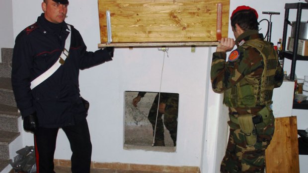 Italian police reveal a secret bunker where an alleged Mafia boss was found and arrested during the raids.