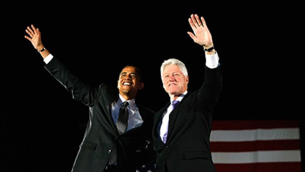 Barack Obama (left) and former President Bill Clinton stand together during a campaign rally in Orlando, Florida.