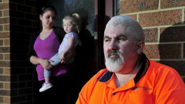 Michael Richer sits outside his house in Latham with his daughter Kylie Richer and granddaughter Sarah Watson after he lost his job from Douglas Quality Joinery.