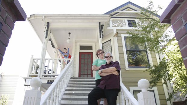 Barbara Holmes and Tom Williams, pose on the steps their Victorian home, where notorious landlord Dorothea Puente murdered and buried the bodies of her victims, in Sacramento, California.