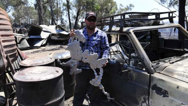 UNRECOGNISABLE: Son Mark Webster with melted metal from his property.